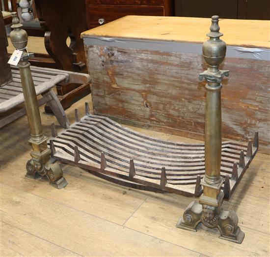 A brass and cast iron fire basket and a pair of brass dogs